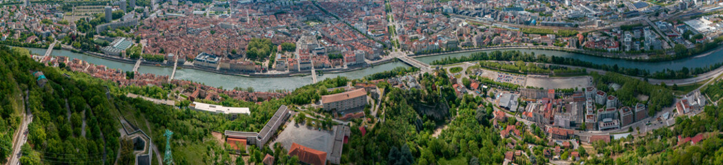 Aerial view of Grenoble's Bastille fort, city skyline crossed by the river and surrounded by...