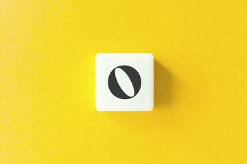 Capital Letter O. Text on Block Letter Tiles against Yellow Background.