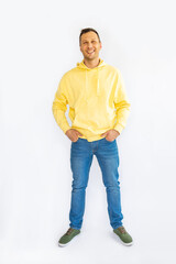 Full body photo of charming cheerful positive young man hold hands pockets isolated on white background