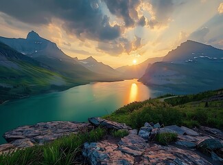 The beautiful sunrise over St Mary Lake in Glacier National Park, with black rock cliffs and turquoise water, mountains, green grassy hills, was photographed  - Powered by Adobe