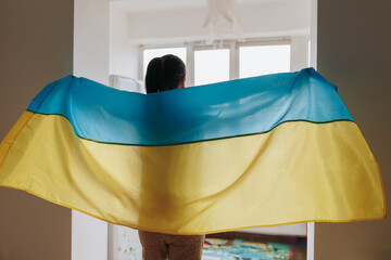 Homebound Allegiance Rear View of Woman and Ukrainian Flag