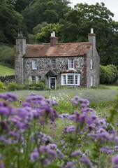 Stone cottage in a field of purple flowers