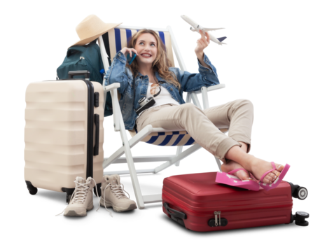 Tourist woman in travel attire, on deck chair with trolley suitcases, show a model airplane, using mobile phone. Summer beach holiday, flight and vacation travel booking. Travel influencer lifestyle