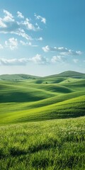 Naklejka premium Green rolling hills under blue sky with white clouds