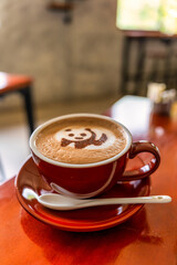 Panda-Themed Coffee Cup in a Vertical Café Setting