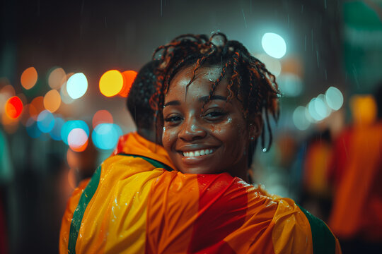 Emotional embrace between teammates after scoring a crucial goal in the African Cup of Nations .Happy couple in orange jacket embrace at event, smiling for flash photography