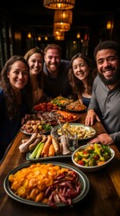 A group of five friends sitting at a table and eating a large meal together