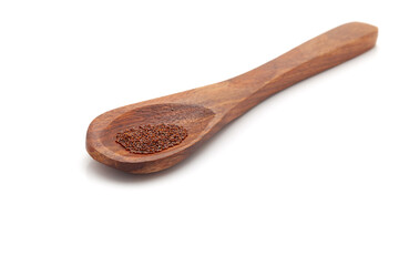 Front view of a wooden spoon filled with Organic Petunia (Petunia exserta) seeds. Isolated on a...