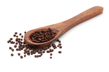 Front view of a wooden spoon filled with Organic Balsam (Impatiens balsamina) seeds. Isolated on a white background.