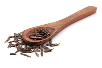 Front view of a wooden spoon filled with Organic Dahlia (Dahlia pinnata) seeds. Isolated on a white background.