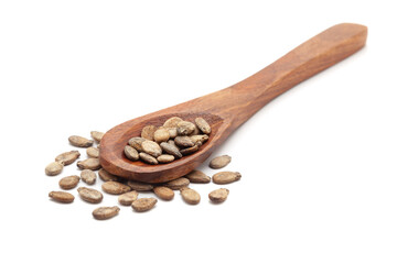 Front view of a wooden spoon filled with Organic Watermelon (Citrullus lanatus) seeds. Isolated on a white background.