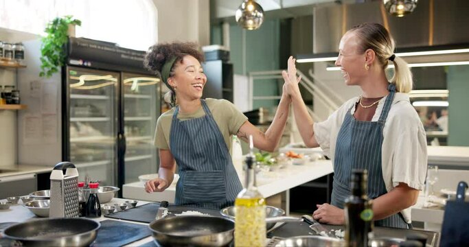 Chef, teamwork and women in kitchen with knife for catering service, fine dining or delicious dish. Hospitality, food and people high five for cooking meal, preparation or dinner rush in restaurant