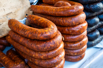 Savory Spanish chorizo hanging, tempting the senses with fast food deliciousness. Tapas