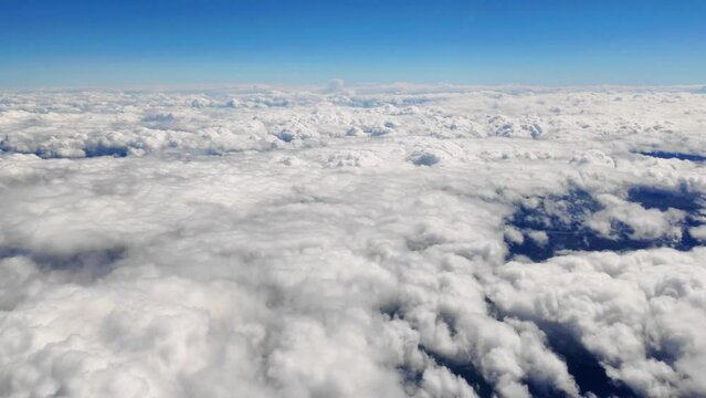 Heaven like clouds with blue sky, flying on an airplane, 4K