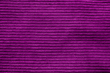 Closeup of magenta corduroy cloth as patterned textured background