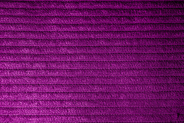 Closeup of magenta corduroy cloth as patterned textured background