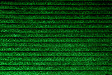 Closeup of green corduroy cloth as patterned textured background