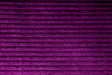 Closeup of magenta corduroy cloth as patterned textured background