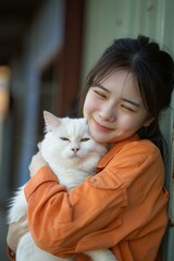 A young woman is hugging a white cat