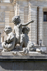 Stone figures of children at  entrance to baroque Hofburg palace, Neue Burg, Vienna, Austria