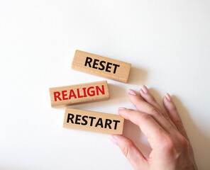 Reset Realign Restart symbol. Concept words Reset Realign Restart on wooden blocks. Businessman...