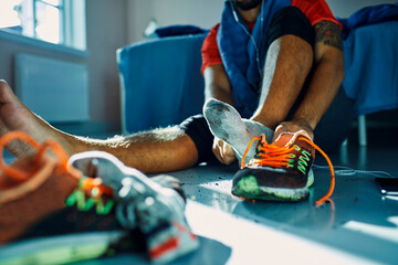 Man taking off dirty shoes at home after workout