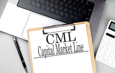 CML-CAPITAL MARKET LINE word on clipboard on laptop with calculator and pen