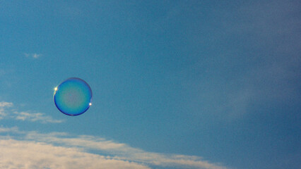 Soap ball against the blue sky.