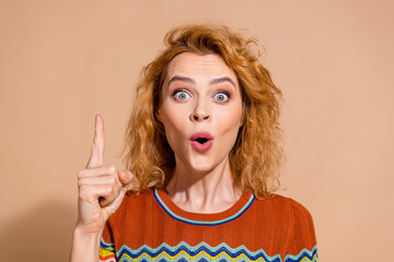Portrait of genius clever girl with ginger hairdo wear knit t-shirt raising finger up have idea...