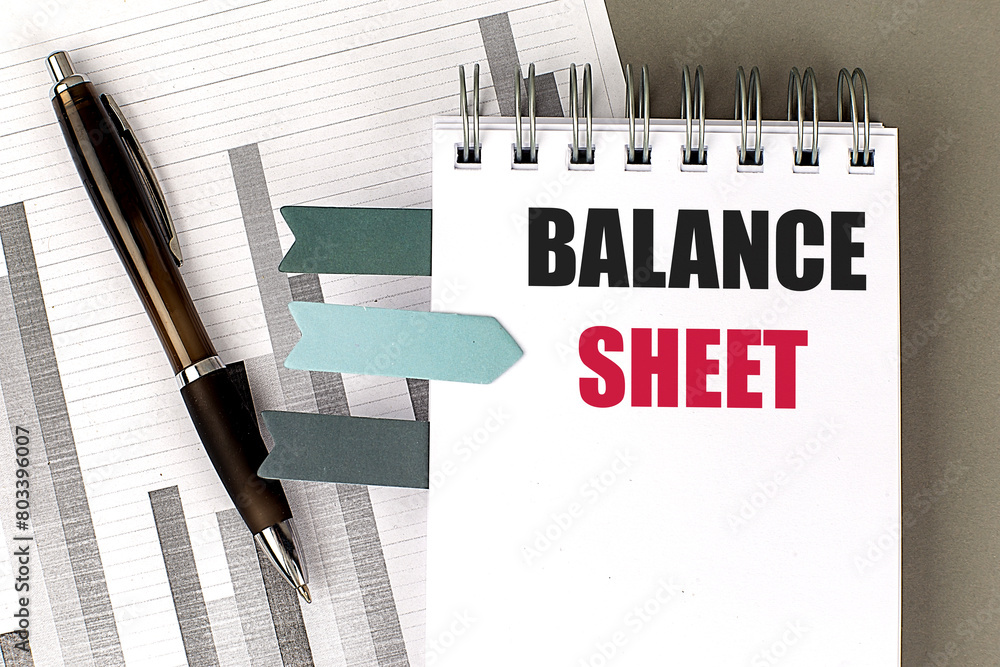 Aufkleber balance sheet text on notebook with chart on gray background