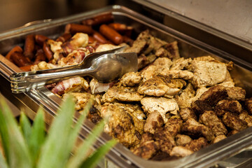 Table decorated with food and salads. Plenty of food on the table. Business event with a table full of food and salads. Catering table full of tasty food.
