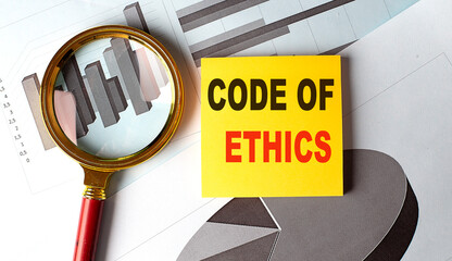 CODE OF ETHICS text on sticky on chart background