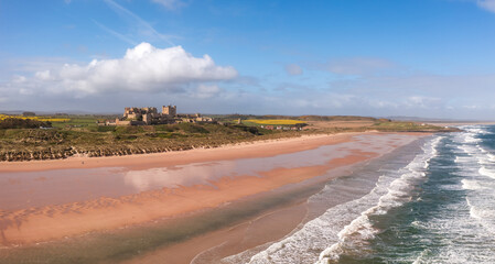 Aerial panorama landscape of Bamburgh and sand dunes in Northumberland