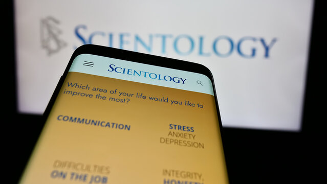 Stuttgart, Germany - 04-15-2024: Mobile phone with website of religious organisation Scientology in front of logo. Focus on top-left of phone display.