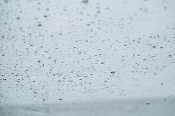 Rain falling on top of a white net cloth