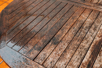 Rain falling on a teak wood table
