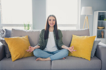 Full size photo of pretty young woman sit couch meditate wear shirt modern interior apartment...