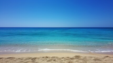 Fototapeta premium Sandy Beach With Blue Water and Blue Sky