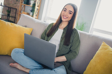 Photo of pretty young woman sit couch use laptop wear shirt modern interior apartment indoors
