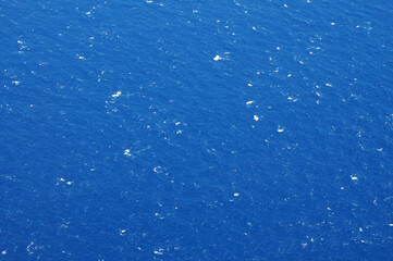 Vast Ocean Expanse With Scattered Whitecaps Under Clear Blue Sky