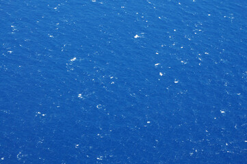 Vast Ocean Expanse With Scattered Whitecaps Under Clear Blue Sky