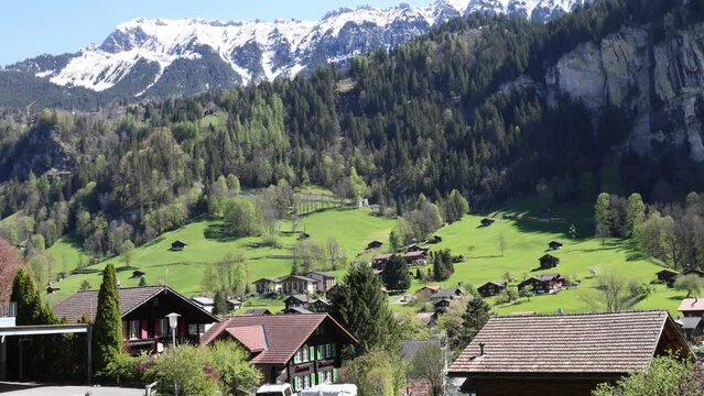 Train driving uphill to Wengen in Lauterbrunnen valley, Swiss mountain landscape