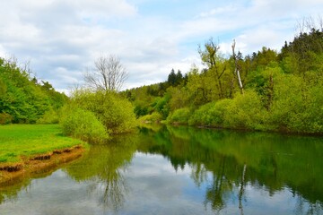 River Rak at Rakov Škocjan with a reflection in the water in Notranjska, Slovenia