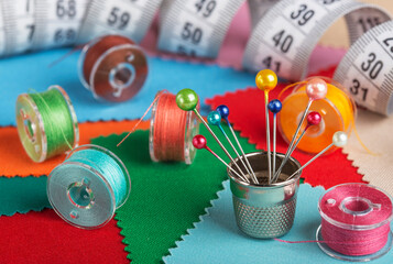 sewing kit, bobbins with colored threads, thimble for sewing.