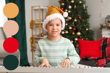 Cute little boy playing synthesizer at home on Christmas eve. Different color patterns