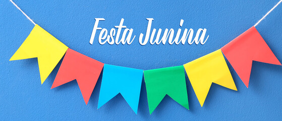Colorful flags for Festa Junina on blue background