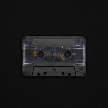 Vintage blank cassette tape on a black background