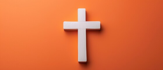 Fototapeta premium Tranquil Elegance: White Cross Embraced by Vibrant Orange