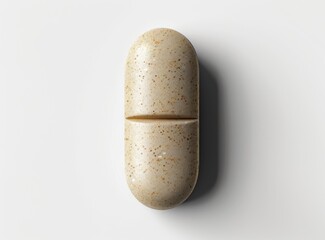 Close-up high-resolution photo of a small oval medicine pill with speckles on a white background