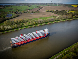 Ship on Kiel Canal loaded with wind turbine blades. Shipping of wind turbine components on cargo...